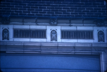 Detail of owls in cornice entablature.