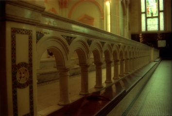 Marble communion railing with inlaid glass mosaics.