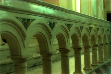 Marble communion railing with inlaid glass mosaics.