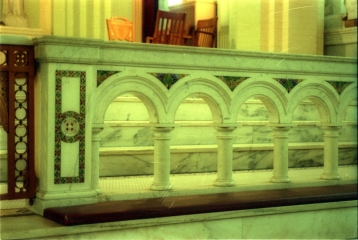 Marble communion railing with inlaid glass mosaics.