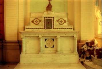 Left side marble altar with inlaid glass mosaics and bronze tabernacle.